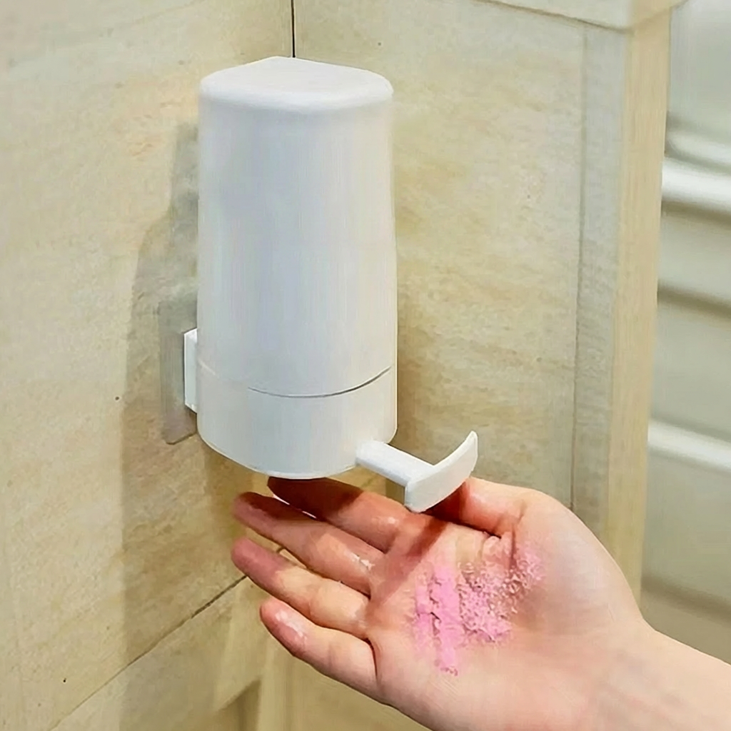 Hand soap dispenser mounted on a wall with a hand holding soap in the foreground.