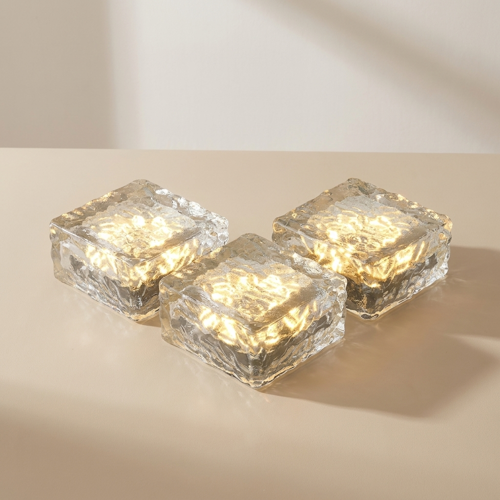 Three square glass lights emitting a warm glow on a beige background