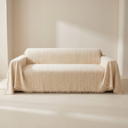 Beige sofa with a textured cover in a minimalistic room.