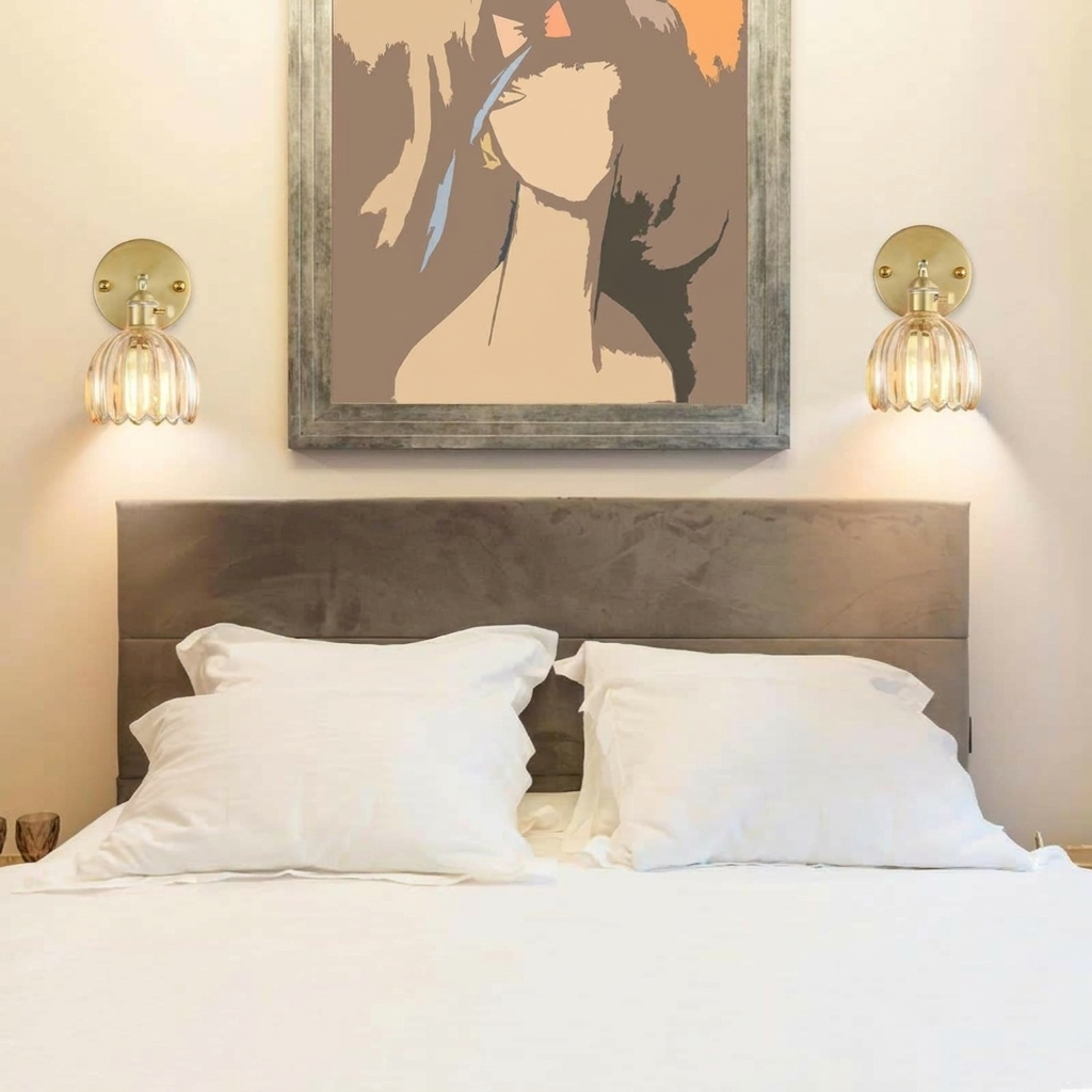 Bedroom with a bed, headboard, and wall art above.