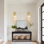 Modern interior with wall sconces, a console table, and decorative items.