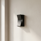 Modern wall-mounted light fixture on a neutral wall