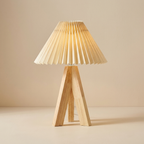 Wooden table lamp with pleated beige shade on a beige background