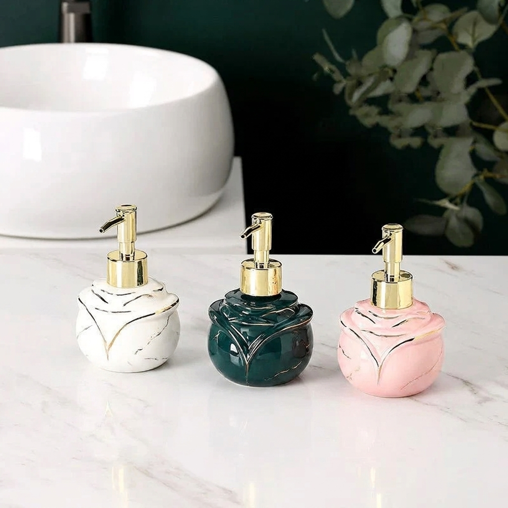 Three ceramic soap dispensers with marble patterns in white, green, and pink on a marble surface.