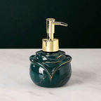 Green soap dispenser with gold accents on a white surface
