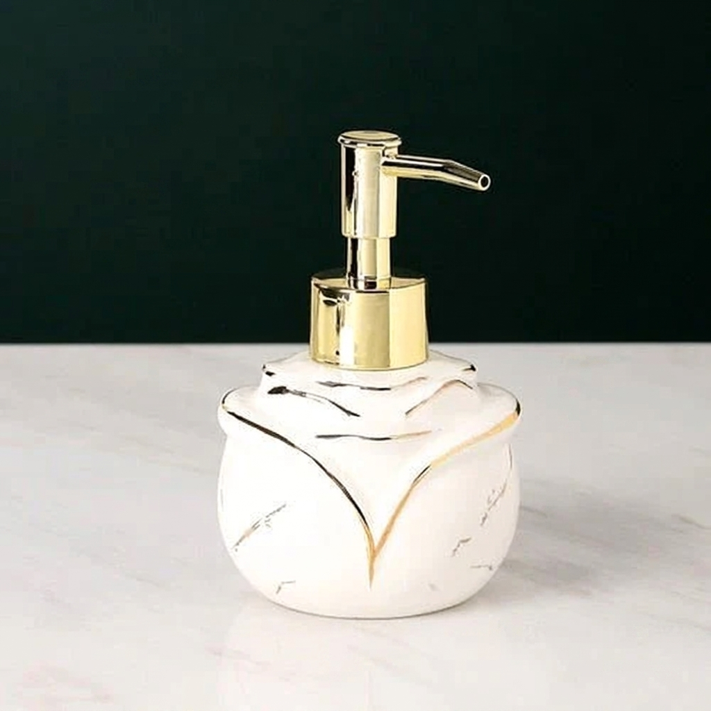 Soap dispenser with gold pump and marbled design on a white surface
