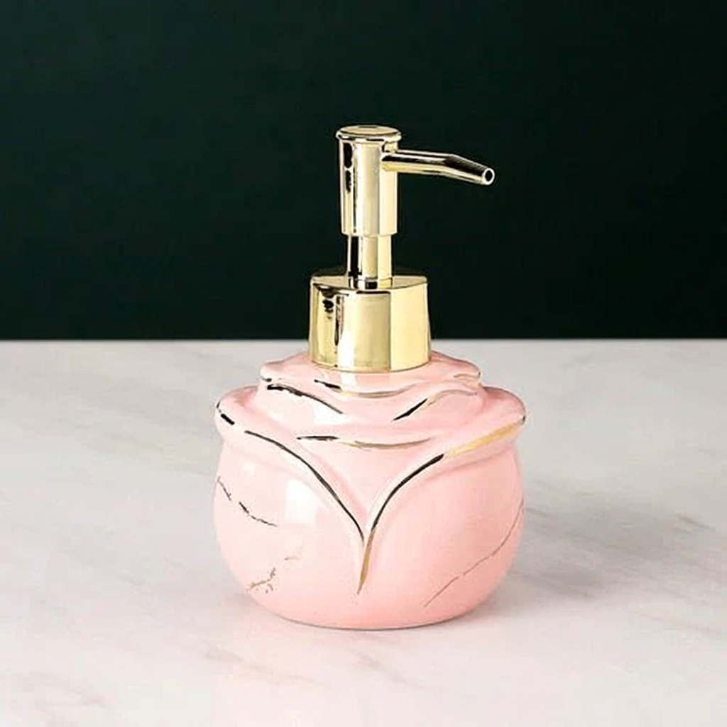 Pink marble-patterned soap dispenser with gold pump on a white surface