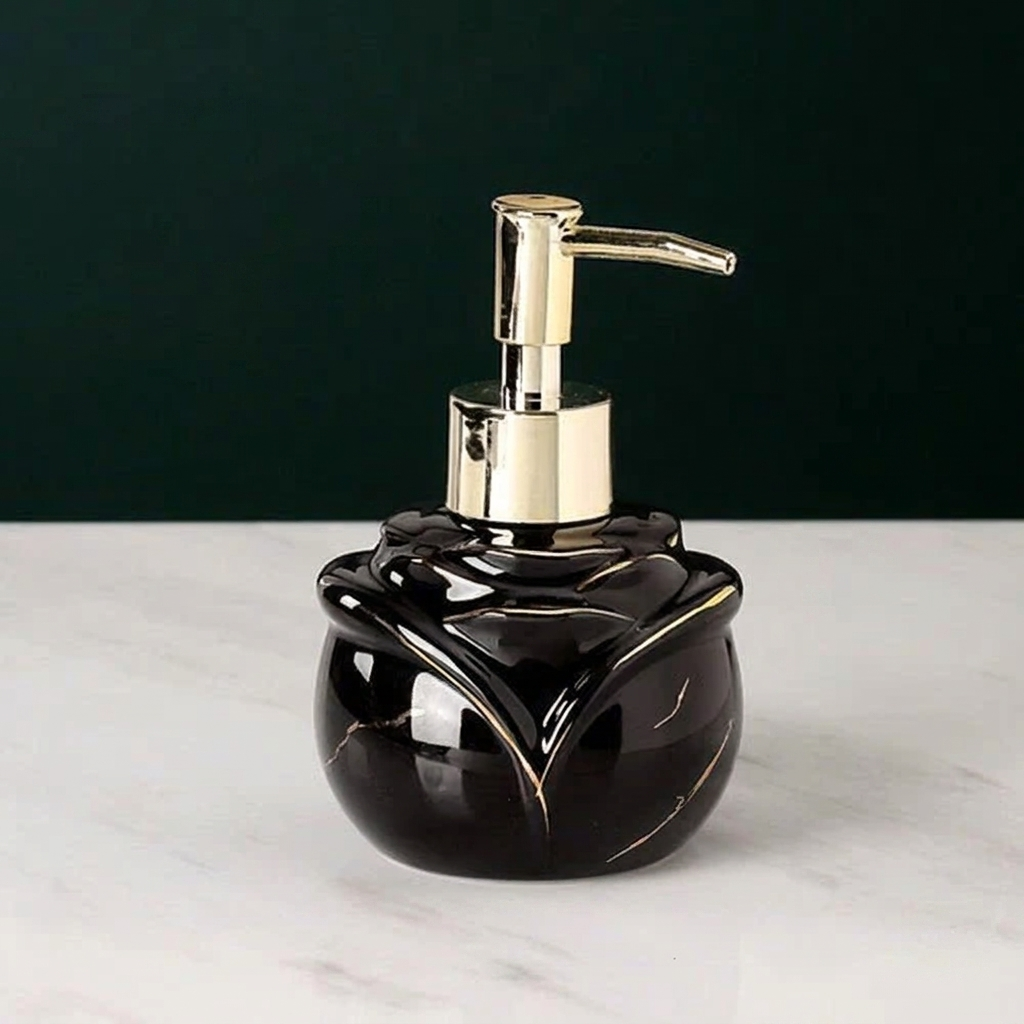 Black marbled soap dispenser with gold pump on a white surface and dark background