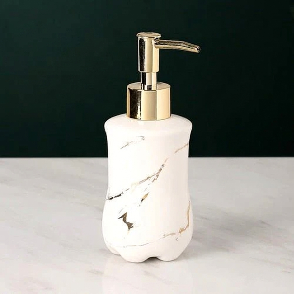 Marble-patterned soap dispenser with gold pump on a white surface against a black background