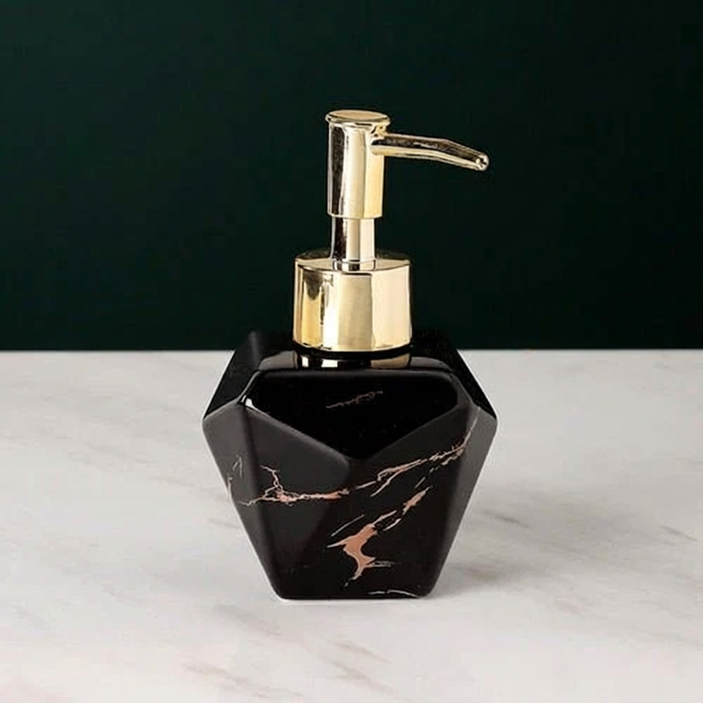 Black marbled soap dispenser with gold pump on a white surface and dark background