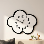 Cloud-shaped wall clock on a wall with decorative items below.