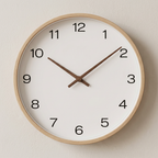Wall clock with wooden frame and white face on a beige wall
