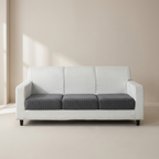 White sofa with gray cushions in a minimalistic room.