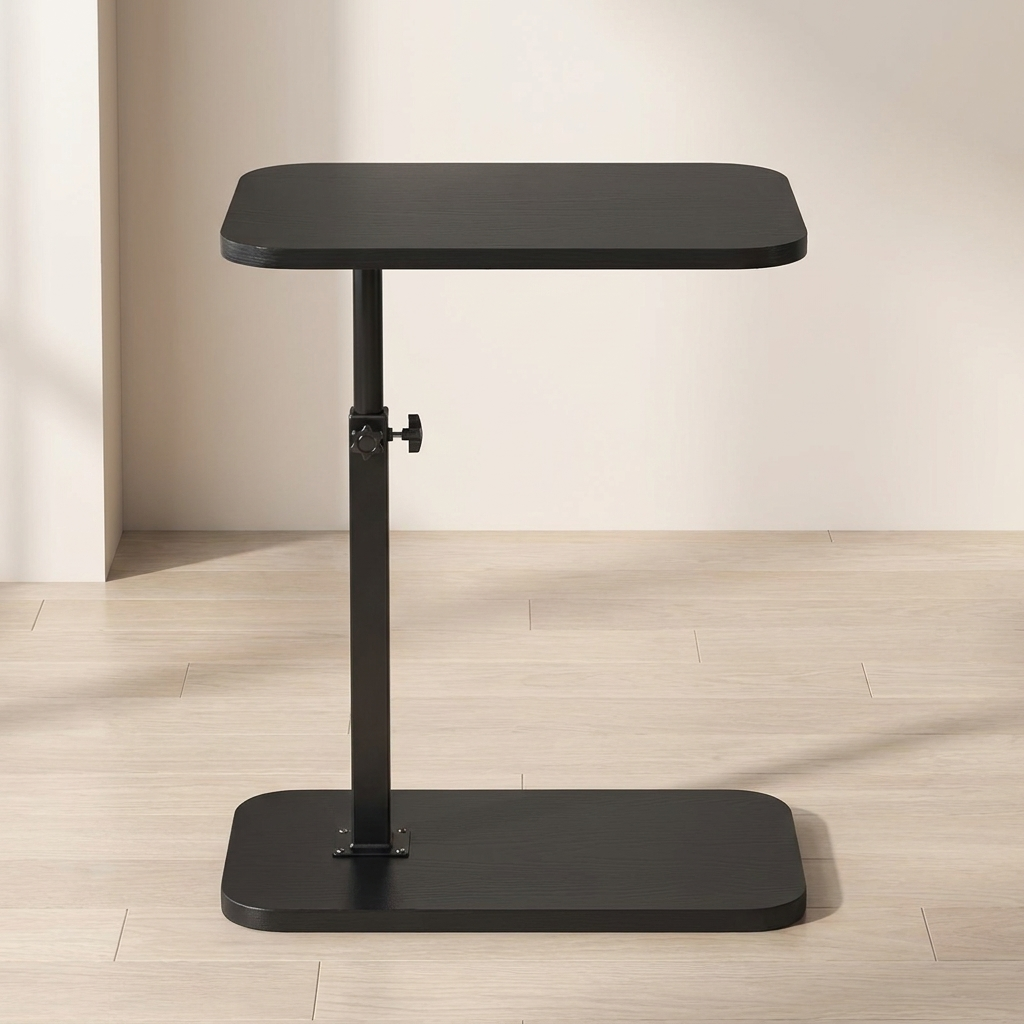 Black adjustable table on a wooden floor with a neutral wall background