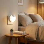 Bedroom setting with a wall lamp, side table, and bed.