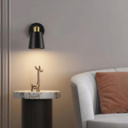 Decorative wall lamp and table lamp on a marble surface with a sofa in the background.