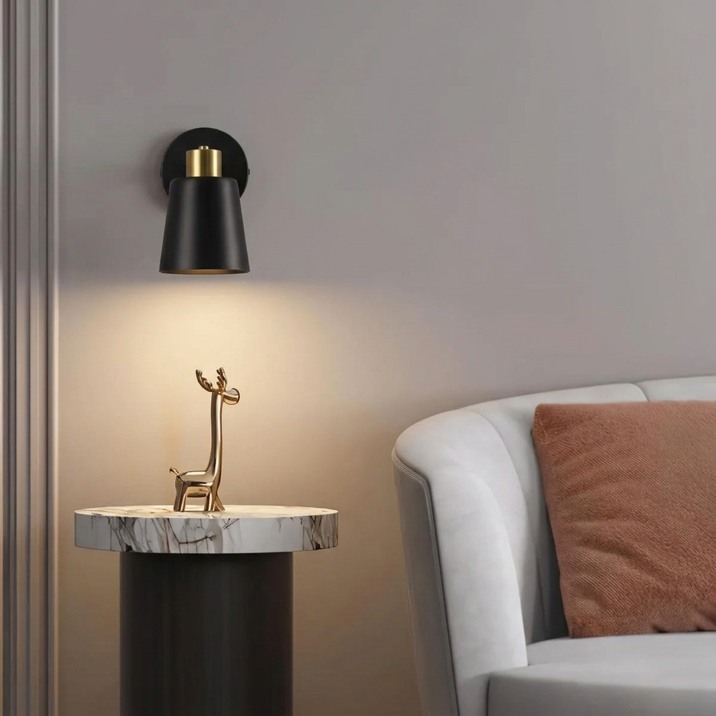 Decorative wall lamp and table lamp on a marble surface with a sofa in the background.