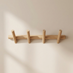 Wooden coat rack with five hooks on a beige background