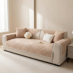 Beige sofa with textured cover and decorative pillows in a living room setting.