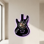 Guitar-shaped wall clock with LED lighting on a beige wall.