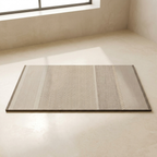 Bamboo mat on a light wooden floor with a window in the background