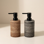 Two soap dispensers with woven designs and black pumps on a beige background