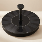 Black circular solar panel on a beige background