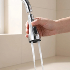 Hand holding a modern kitchen faucet with water flowing