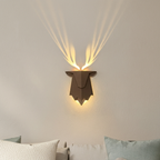 Decorative wall light fixture on a neutral wall with soft lighting.