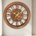 Decorative wall clock with Roman numerals on a plain background