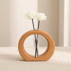 Wooden circular vase with white flowers on a beige background