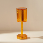 Orange table lamp with ribbed design on a beige background