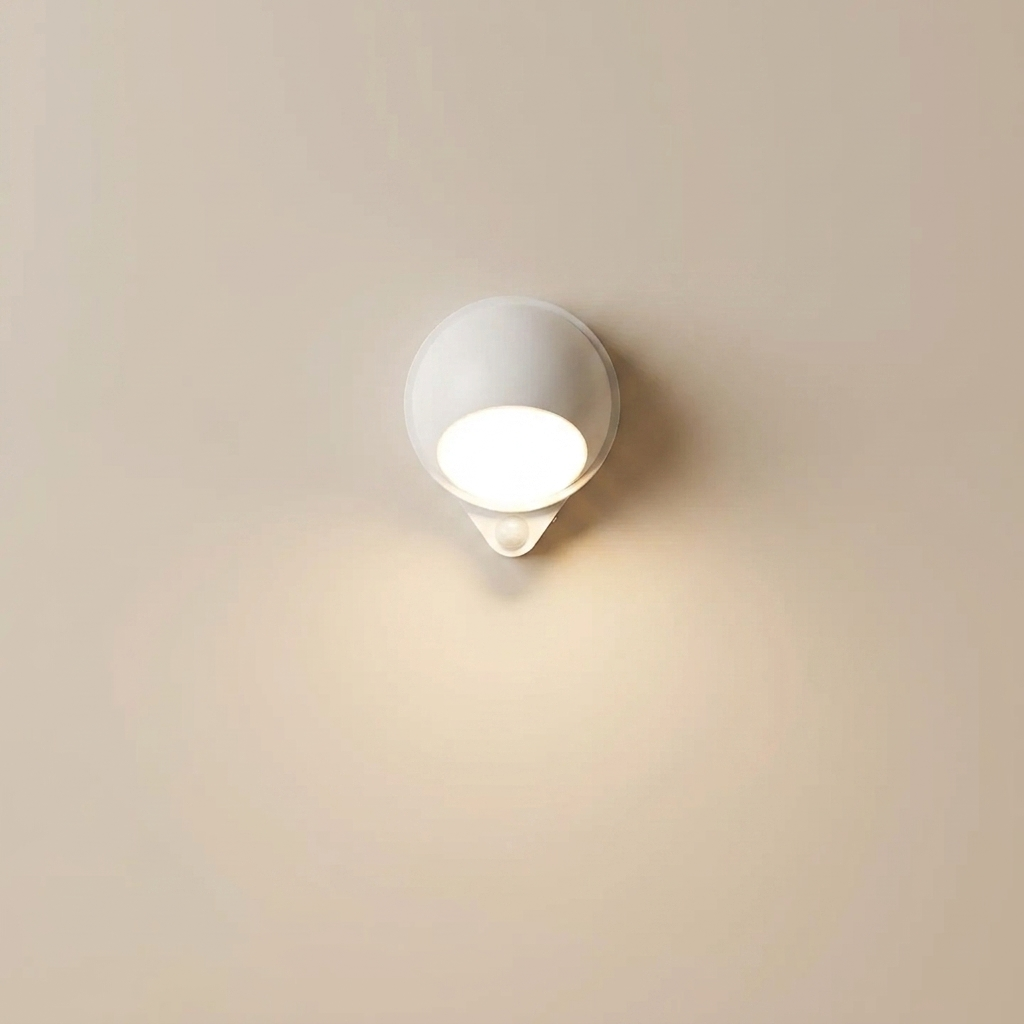 White wall-mounted light fixture on a beige wall