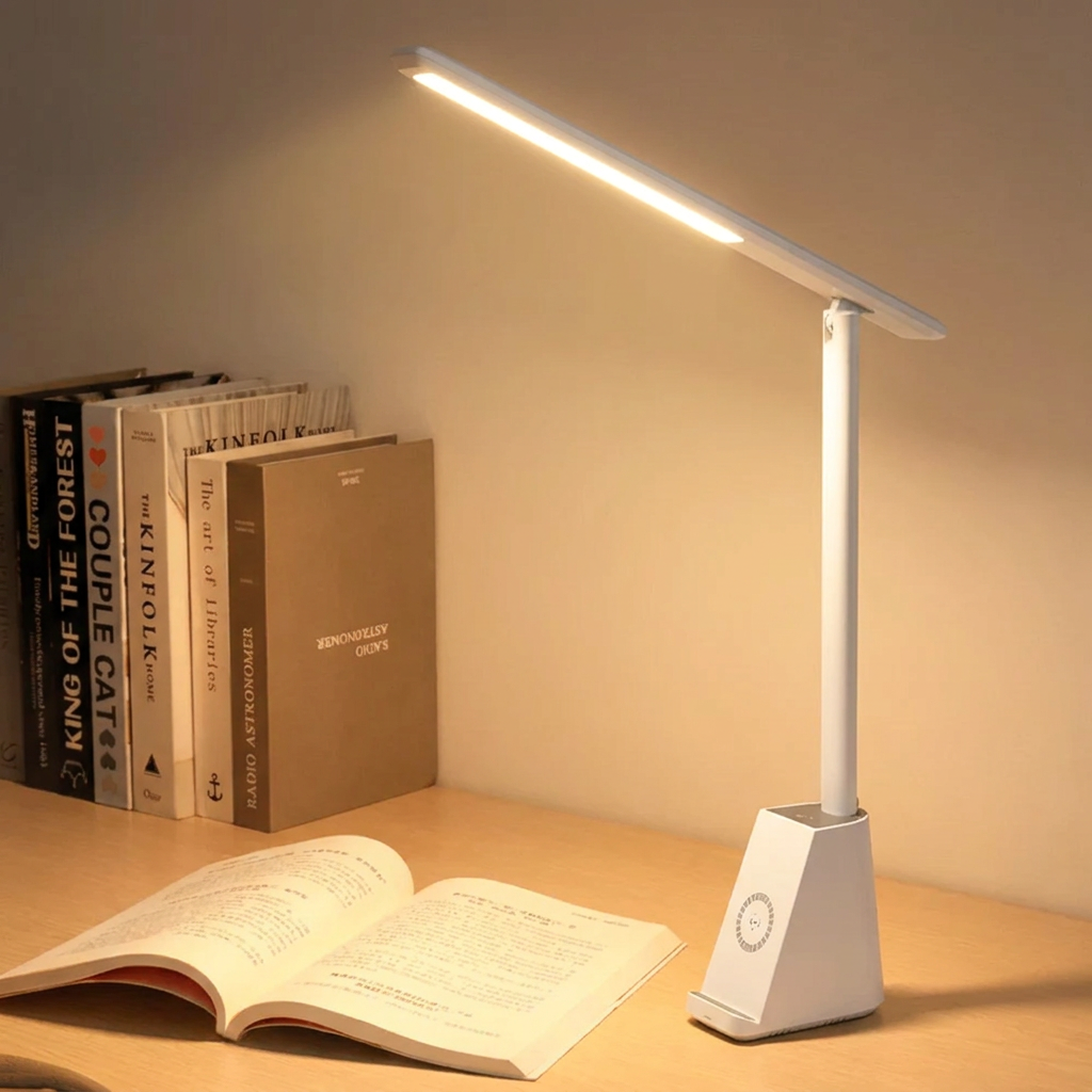 Table lamp on a desk with books and an open book