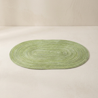 Green oval rug on a beige background