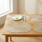 Wooden table with woven placemats and a plate with a fork and knife.