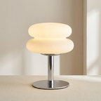 Modern table lamp with a glass shade on a neutral background