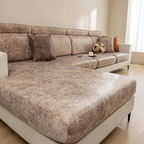 Beige sectional sofa in a living room setting with decor items.