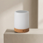 White cylindrical lamp with wooden base on a beige surface