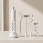 White handheld blender with attachments on a beige surface