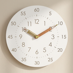 White wall clock with a pencil-shaped hand on a beige background