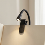 Black booklight on an open book with a neutral background