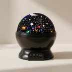 Starry night light projector on a beige surface