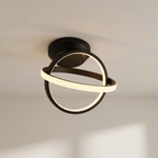 Modern ceiling light fixture with black and gold design on a neutral ceiling.