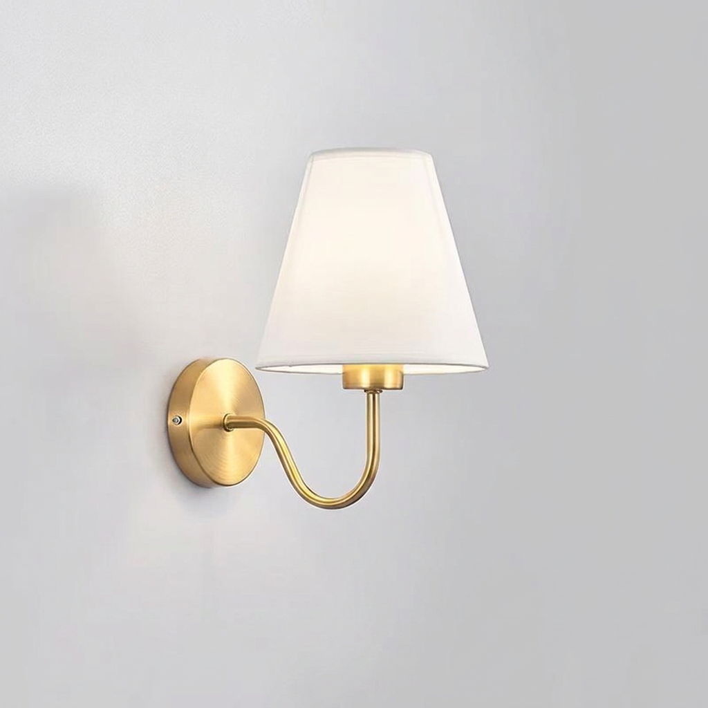 Wall-mounted lamp with a white shade and gold fixture on a light gray background