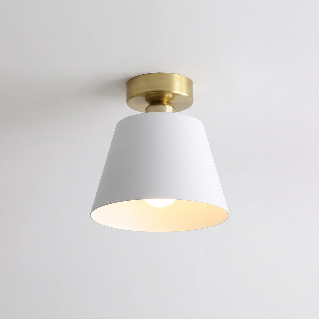 Ceiling light fixture with white shade and gold fixture on a plain background