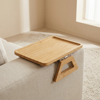 Wooden tray attached to a sofa in a home setting