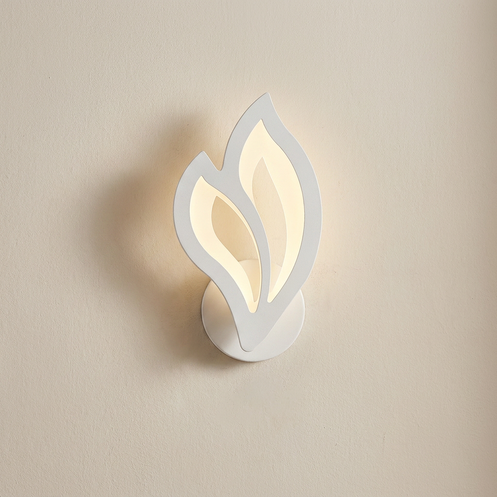 Wall-mounted light fixture with leaf-like design on a beige wall