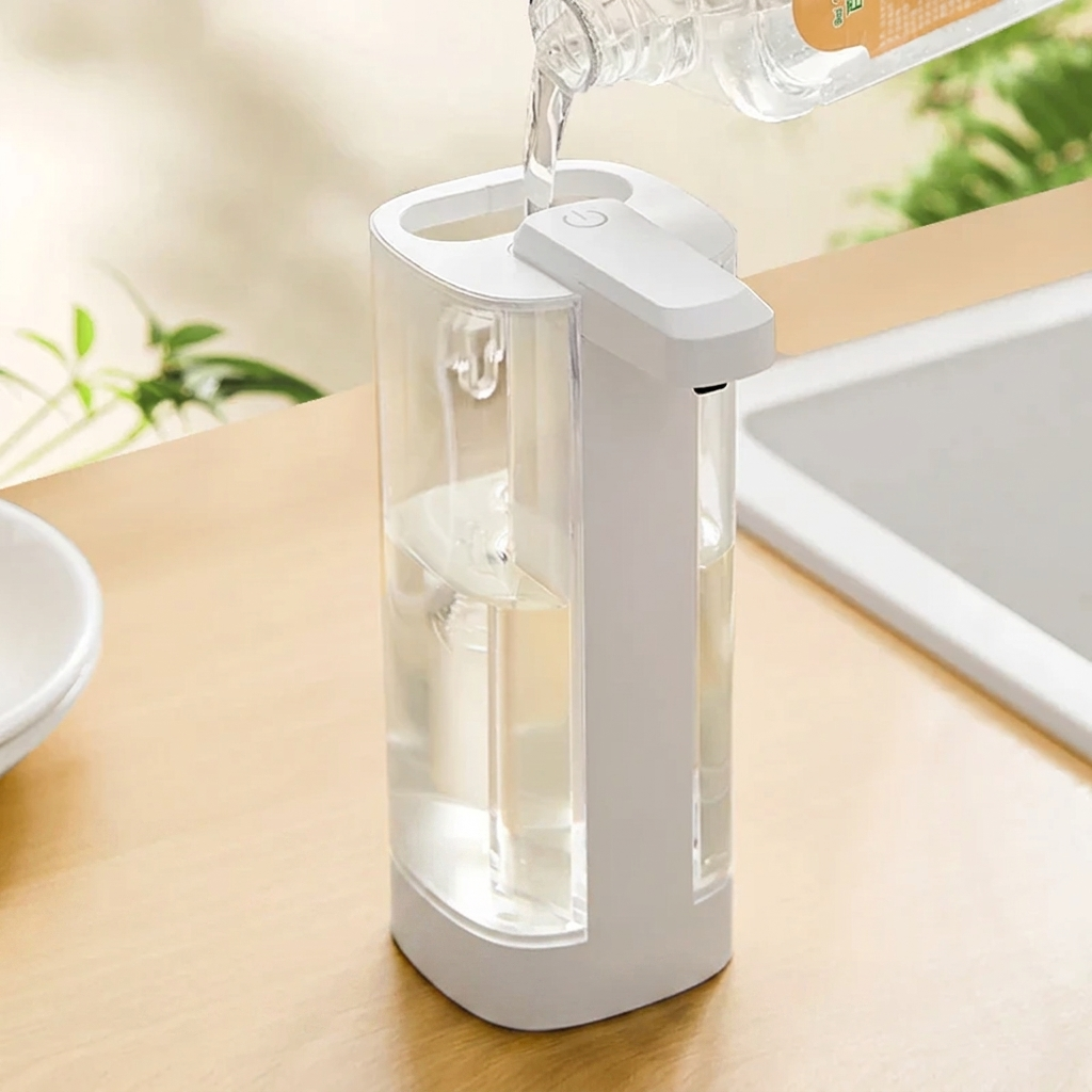 White soap dispenser on a kitchen counter with water being poured into it.