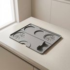Gray kitchen mat with multiple compartments on a light-colored countertop.